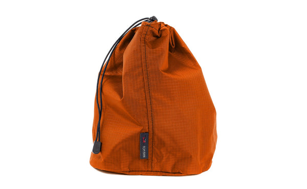 A Size 4 Persimmon (dark orange with orange grid) 210 Cerylon Travel Stuff Sack.